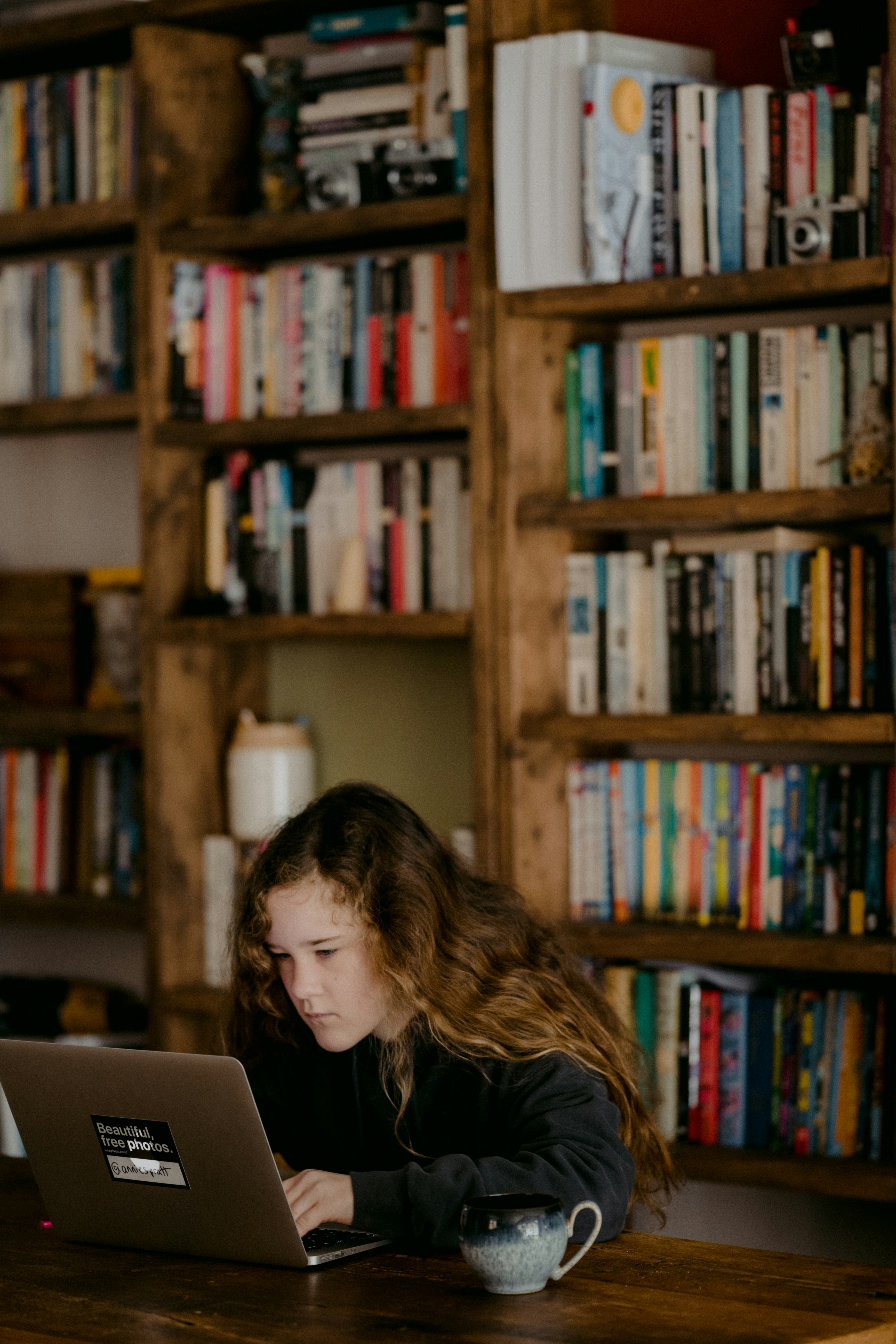 Kid working at a desk in a library