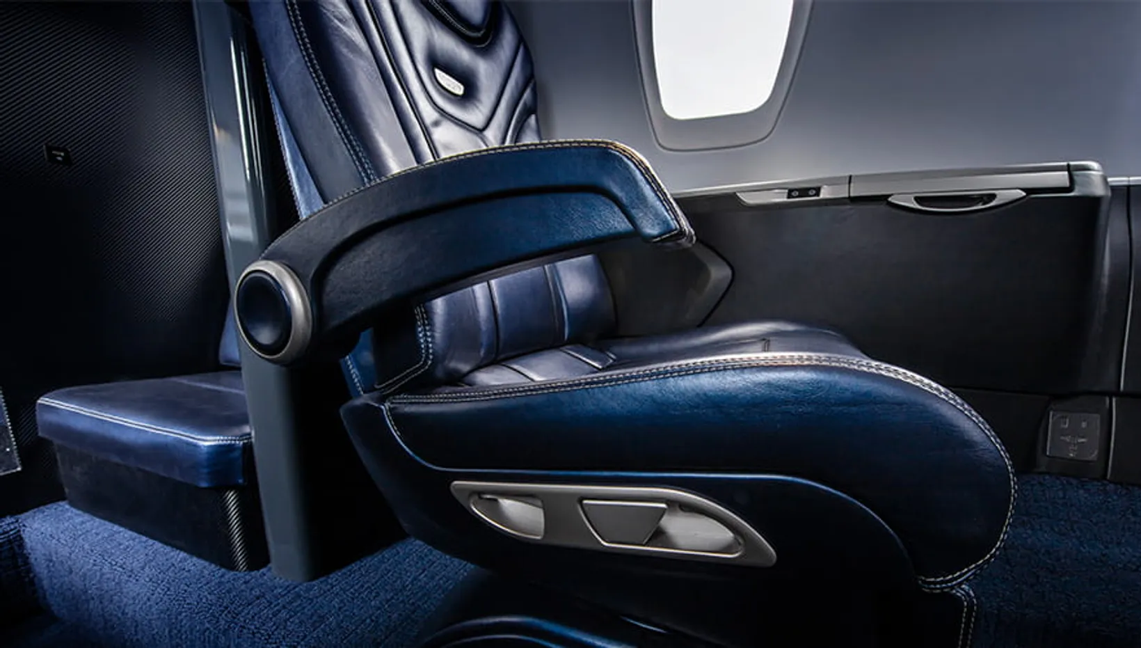 Luxurious cabin interior of a Cessna Citation XLS jet with blue leather seats, white overhead panel, and modern amenities ...