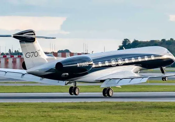 Samolot biznesowy Gulfstream G700 startuje z pasa startowego o zmierzchu