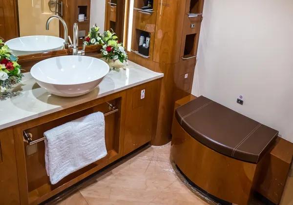 Nowoczesne toalety w prywatnych odrzutowcach z eleganckimi umywalkami, marmurowymi blatami i lustrami