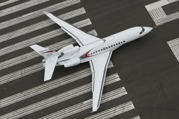 Luxurious private jet cabin with beige seats, glossy table and designer magazine