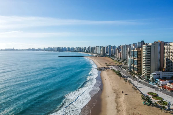 Spiaggia urbana di Fortaleza con grattacieli e passeggiata delle palme