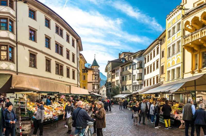 Emberek vásárolnak az óváros piacterén 2018. október 19-én Bolzanóban, Olaszországban