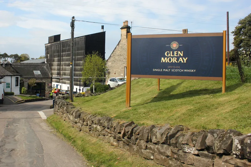 the entrance of the famous glen moray distillery on a sunny day