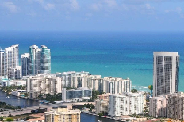 Napsütötte kilátás Miami West Palm Beachre felhőkarcolókkal, tengerrel és a Collins-csatornával