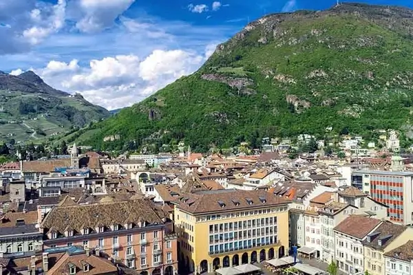 Aerial view of the rooftops of the city of Bolzano in Italy with mountains in the background