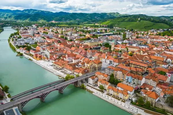 Aerial view of Solothurn, Switzerland showing the historic old town with red-roofed buildings along the turquoise Aare River and arched bridge