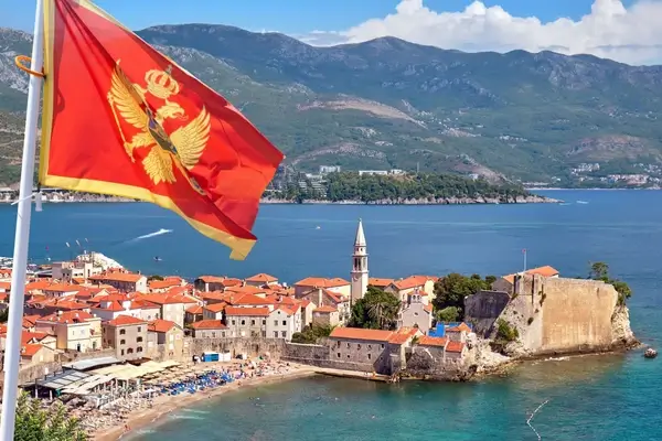 Historic Old Town Budva with the national flag of Montenegro prominently displayed