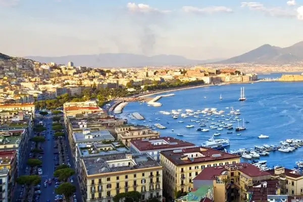 Naples port in summer with boats and the Mediterranean sea and mount vesuvius in the background