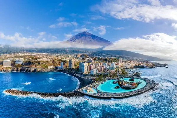 Aerial view with Puerto de la Cruz, in background Teide volcano, Tenerife island, Spain