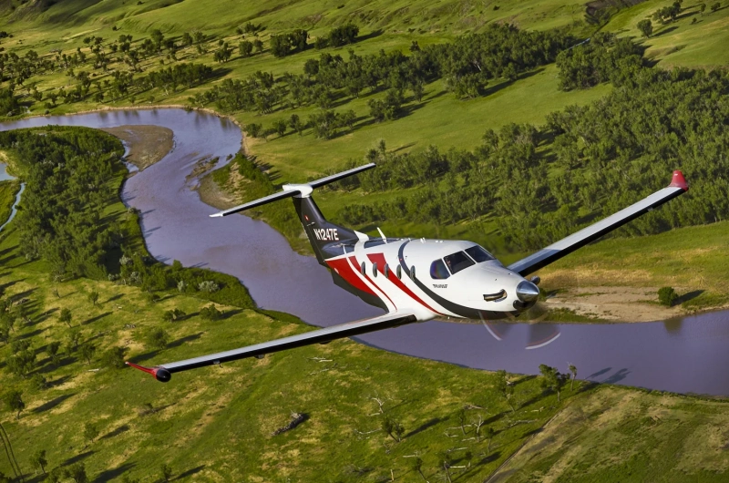 Pilatus PC-12, the green jet flying over Mount Rushmore, South Dakota, USA.