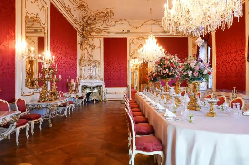 A red and gold baroque dining hall with crystal chandeliers, Belgrade
