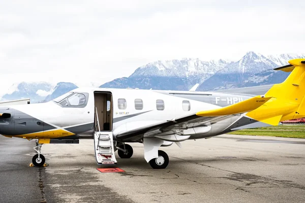Pilatus PC-12 NG aircraft parked on tarmac with open cabin door and deployed stairs