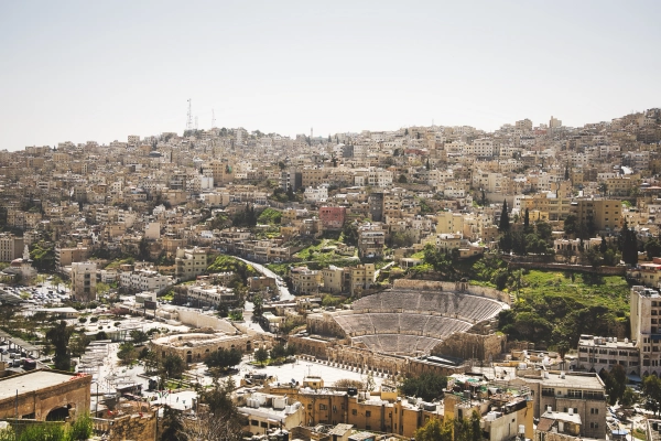 Amman’s Roman Theatre surrounded by streets and buildings spreading across the city’s hillsides