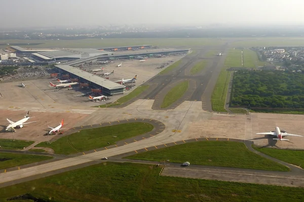 Aerial view of Indira Gandhi International Airport in Delhi, showing terminal buildings, aircraft stands and taxiways