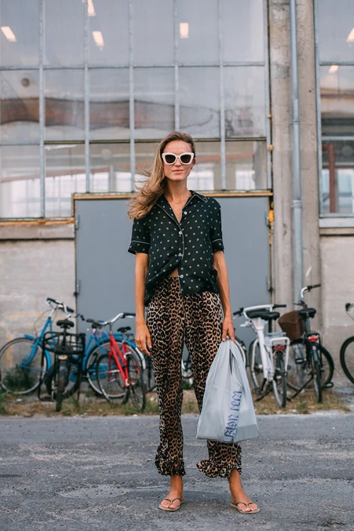 Leopard pants styled with a vintage polka dot blouse and flip flops for a playful city cool summer look.