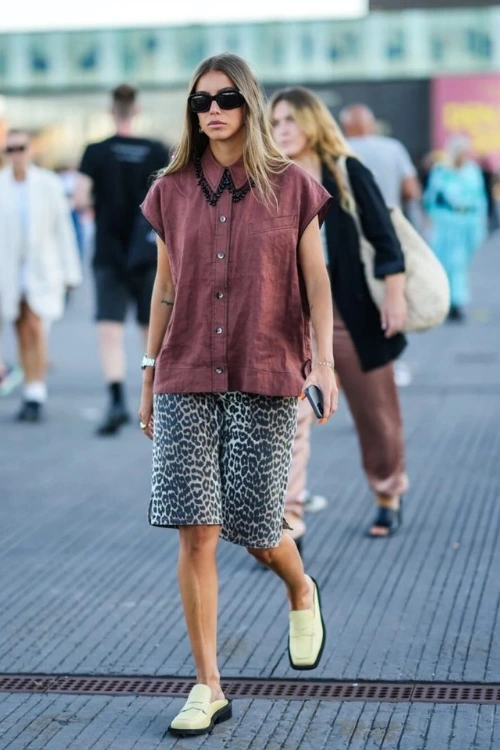 Leopard print Bermuda shorts with a boxy shirt and pastel loafers. A smart casual street style mix.