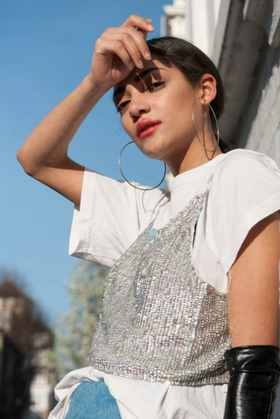 Sequin tank layered over a white tee and gloves. Cool, unexpected evening layering with vintage edge.