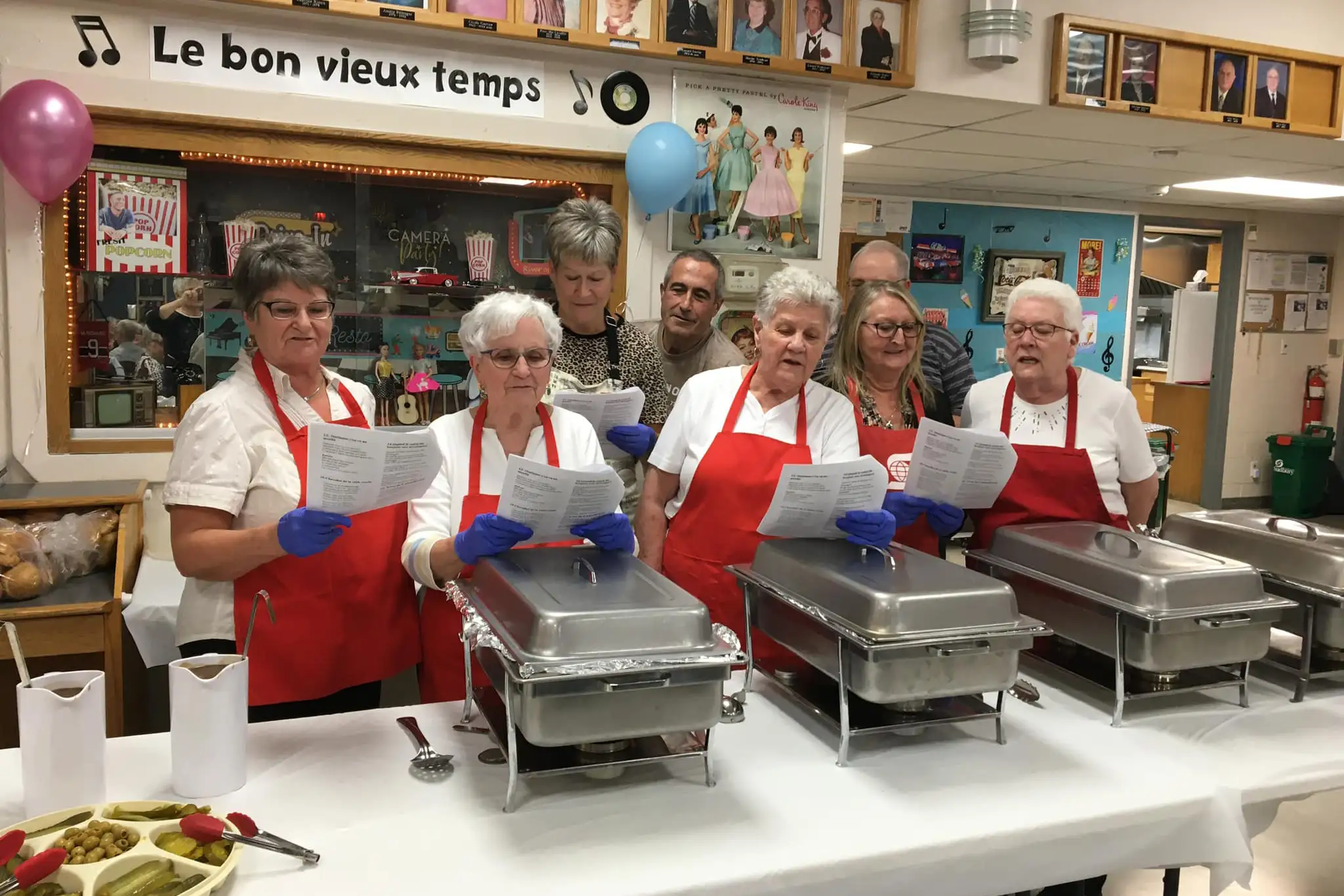 Groupe de bénévoles qui servent le souper lors d'une danse thème.