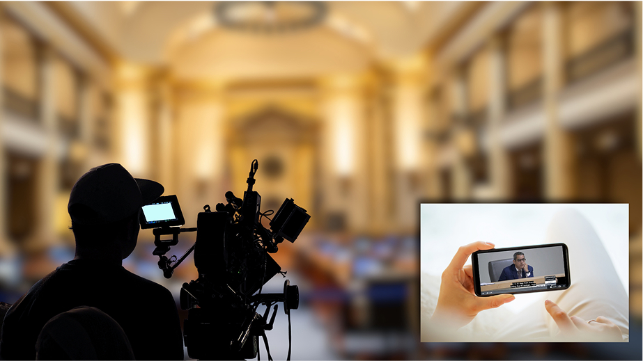 Camera operator filming meeting with live video.