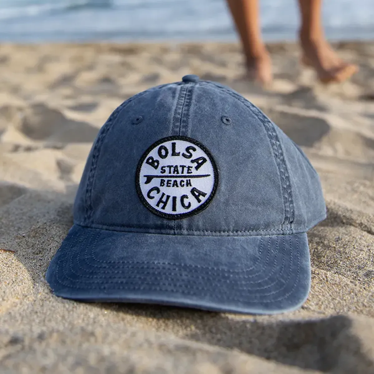 Bolsa Chica State beach hat sitting on sand at beach.