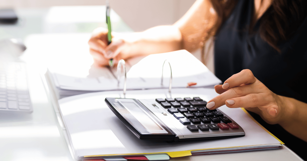 An accounts payable representative using the calculator and manually processing invoices