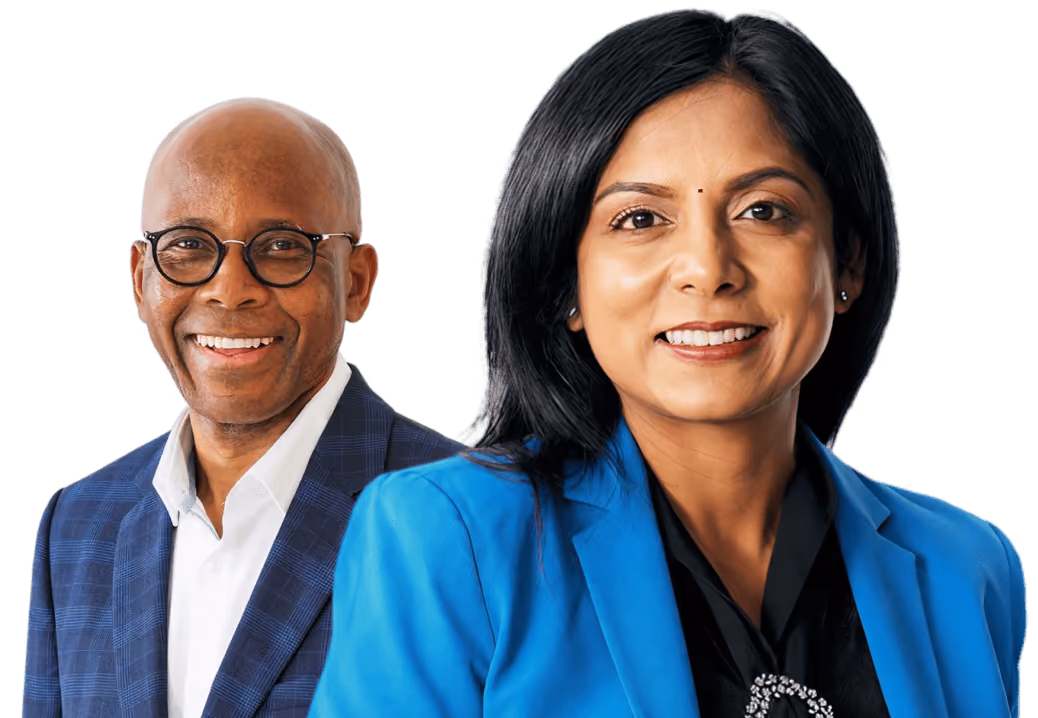Smiling middle-aged man wearing glasses and a blue checkered blazer and a smiling middle-aged woman with black hair wearing a blue blazer and black blouse.