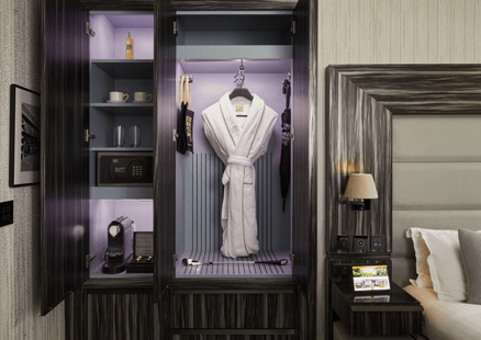 Coffee machine, safe, and room amenities inside the cabinet