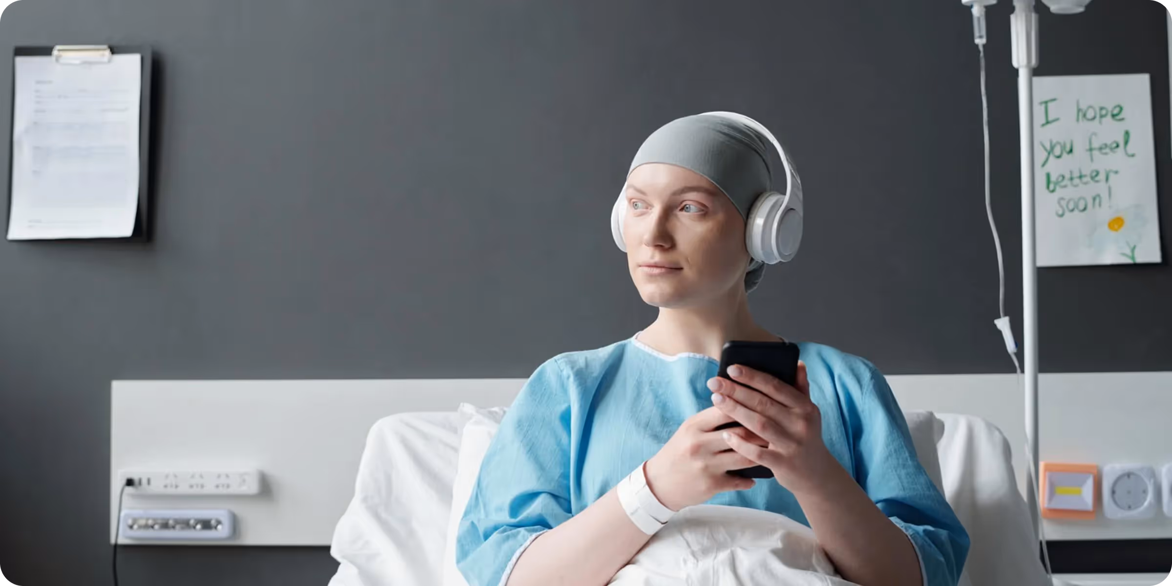 Patient using digital patient engagement platform during hospital stay, enhancing oncology support and adherence.