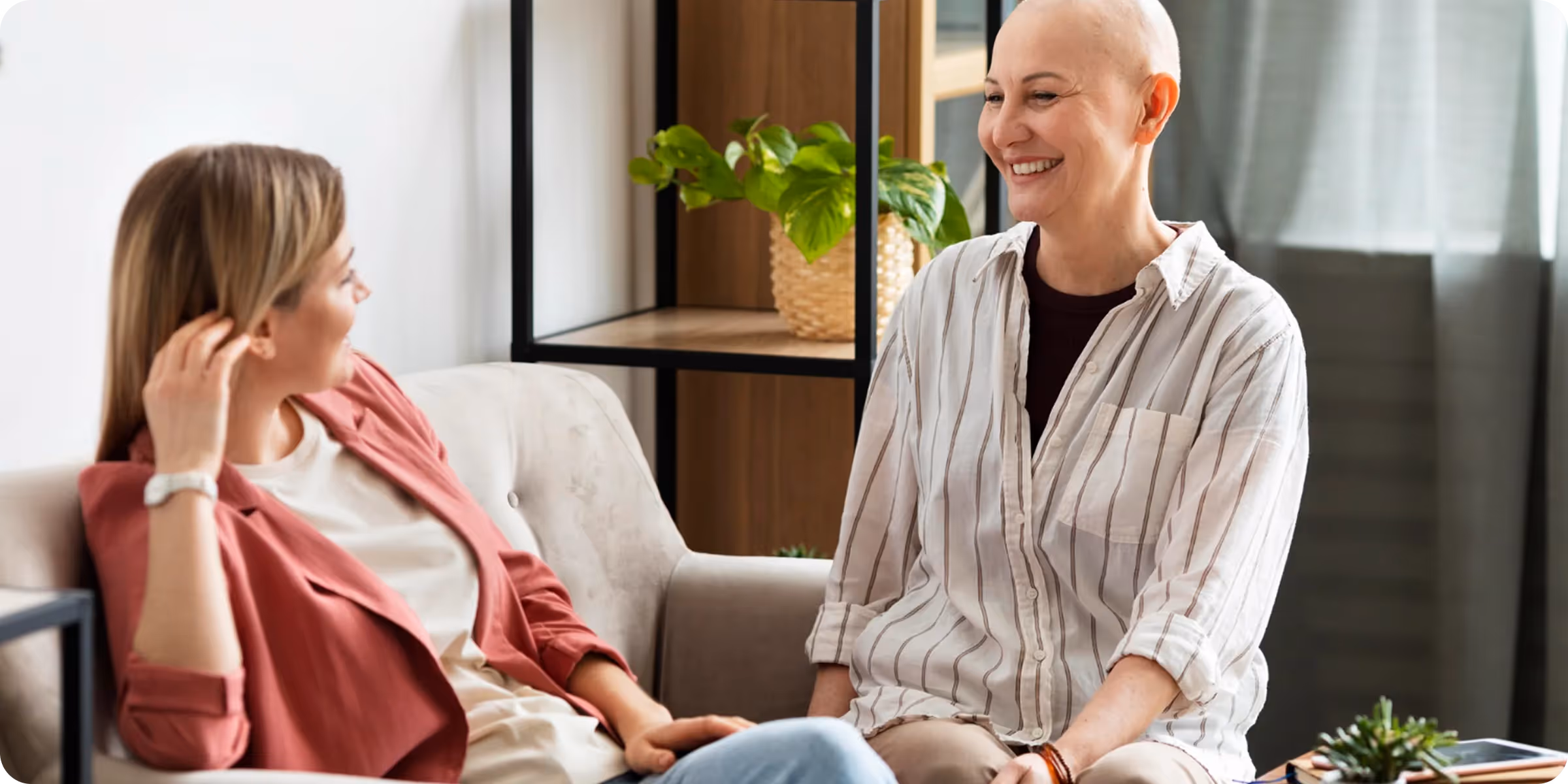 Cancer patient supported by friend during oncology patient support program using digital patient engagement tools.