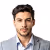 Portrait of a professional Yacht Charter Broker — man with short dark hair, light beard, and grey suit.
