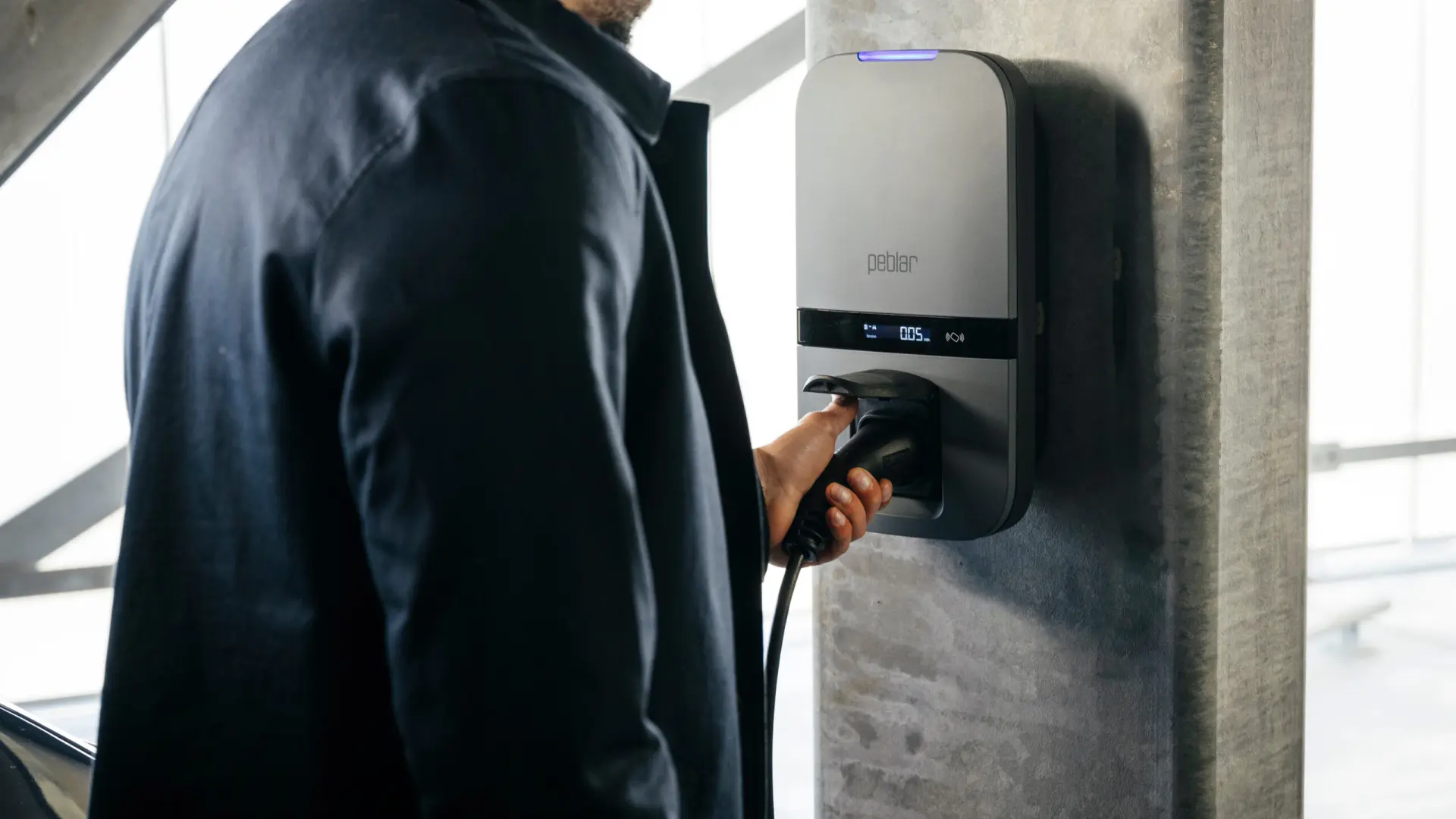 Qobox P wall charging station installed on the facade of a house, used to charge an electric vehicle