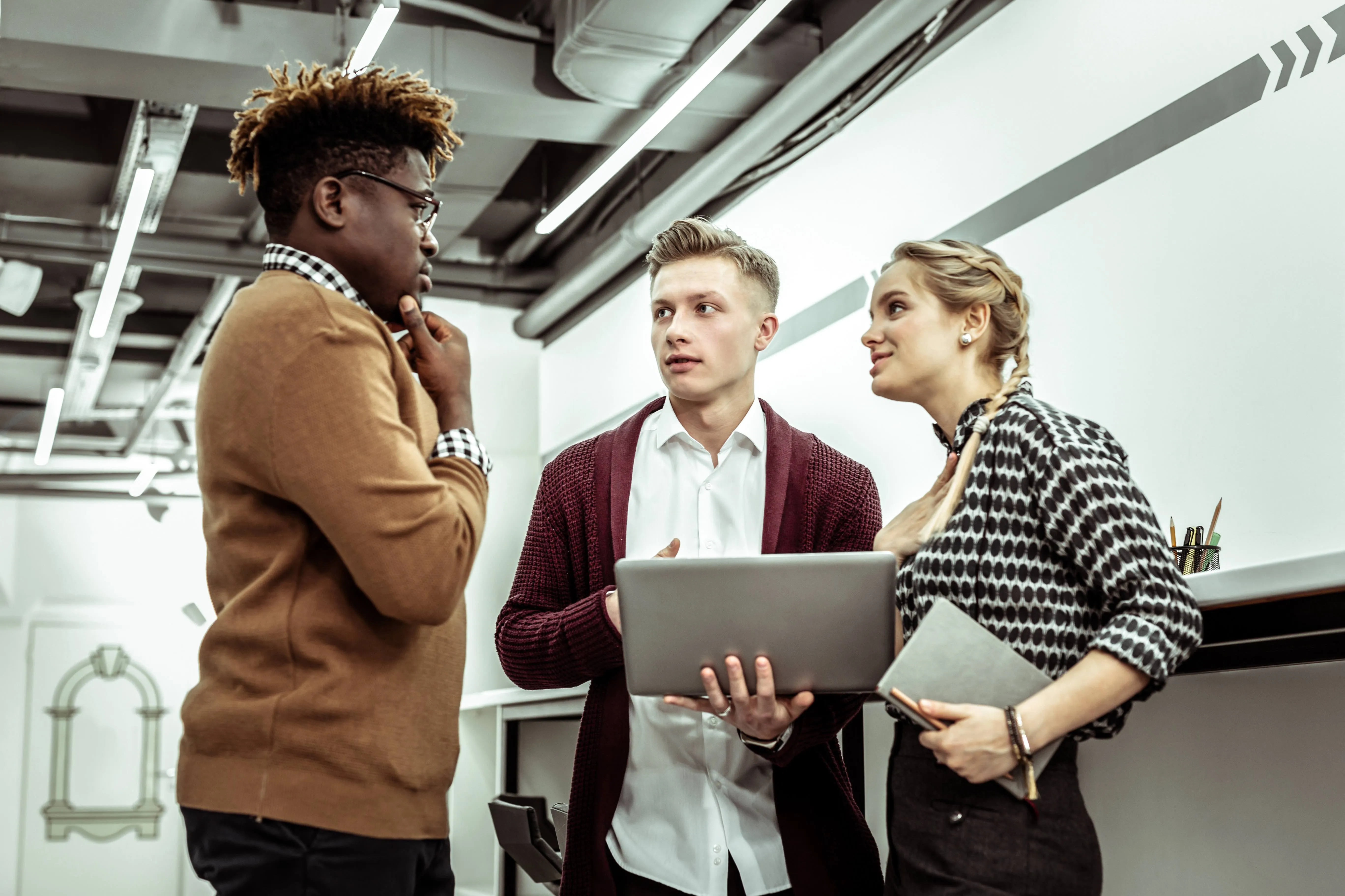 a mans hand typing on a laptop