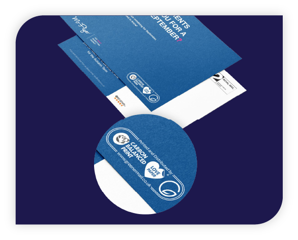 Blue printed mail envelope with a circular zoom-in highlighting the 'Carbon Balanced Print' logo and text.