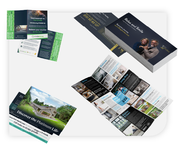 Collection of assorted printed marketing materials including brochures, flyers, and business cards displayed on a white surface.