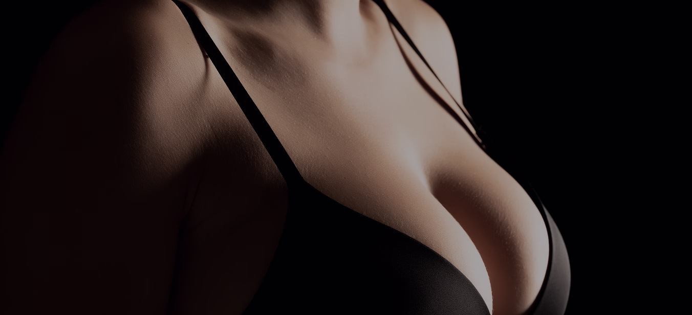 A close-up view of a person wearing a black bra, focusing on the upper body and the neckline.