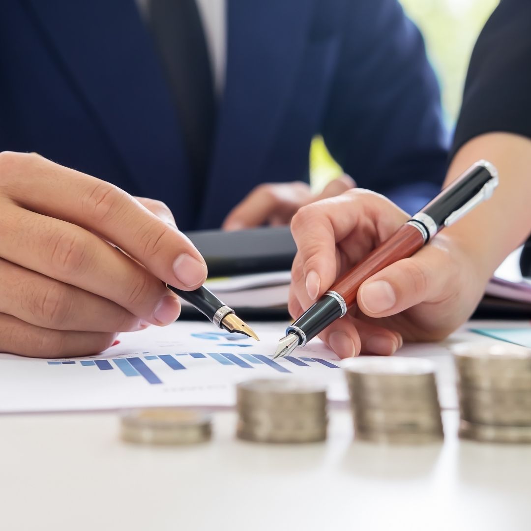 two people looking at financial papers