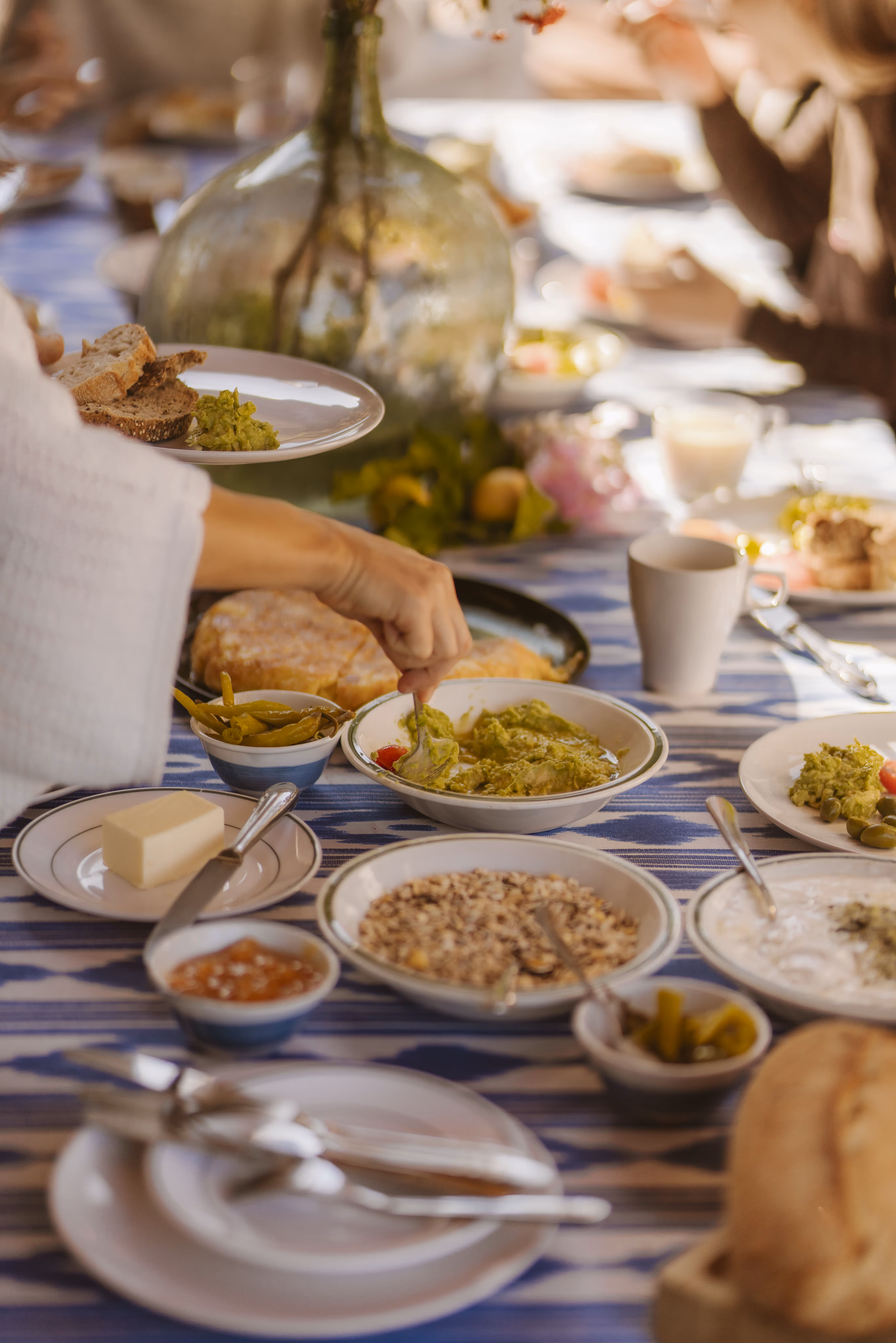Finca Higo brunch table with vegan dishes, healthy dips, and fresh bread prepared for yoga retreat participants.