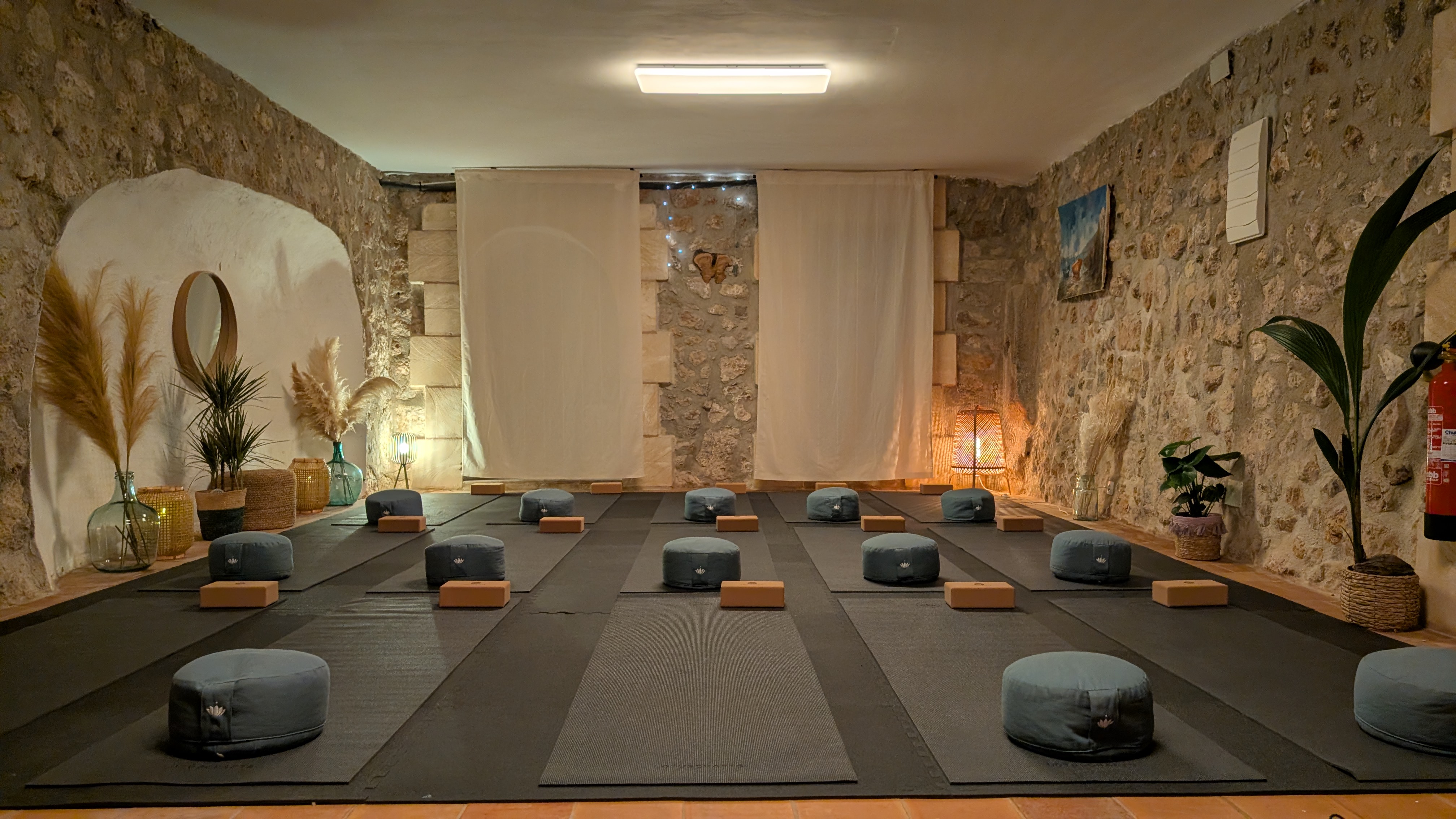 Aerial shot of Finca Higo’s pool area with sun loungers, pergola, and palm tree next to the rustic main house.