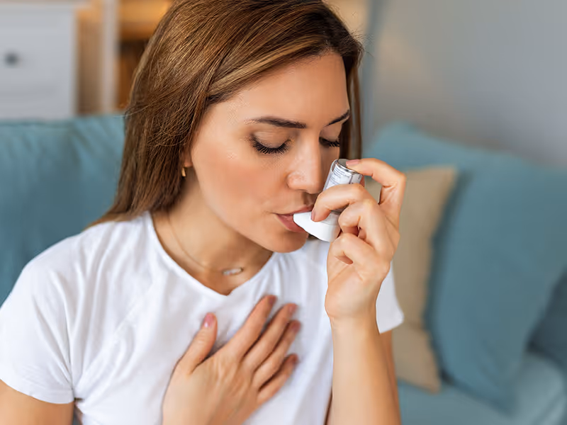 homeowner with inhaler for asthma
