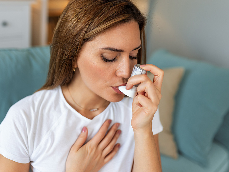 homeowner with inhaler for asthma