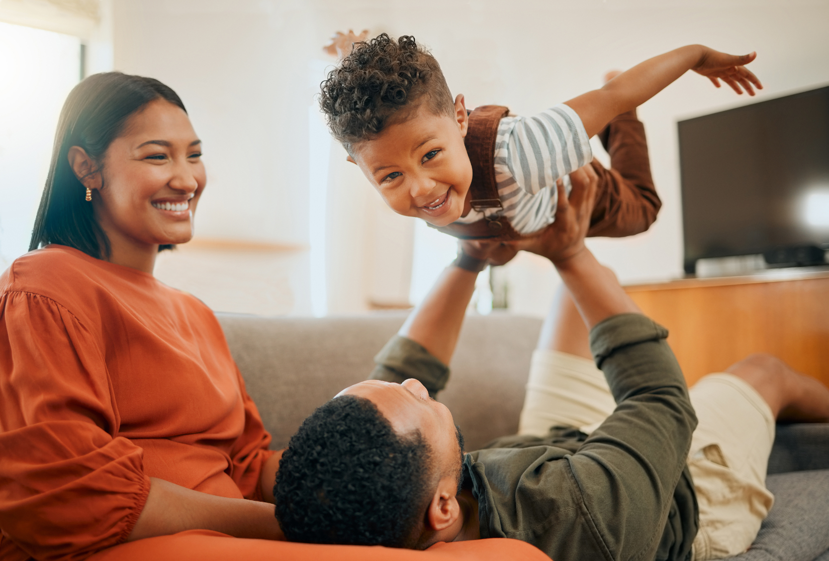 Family playing on sofa stock image