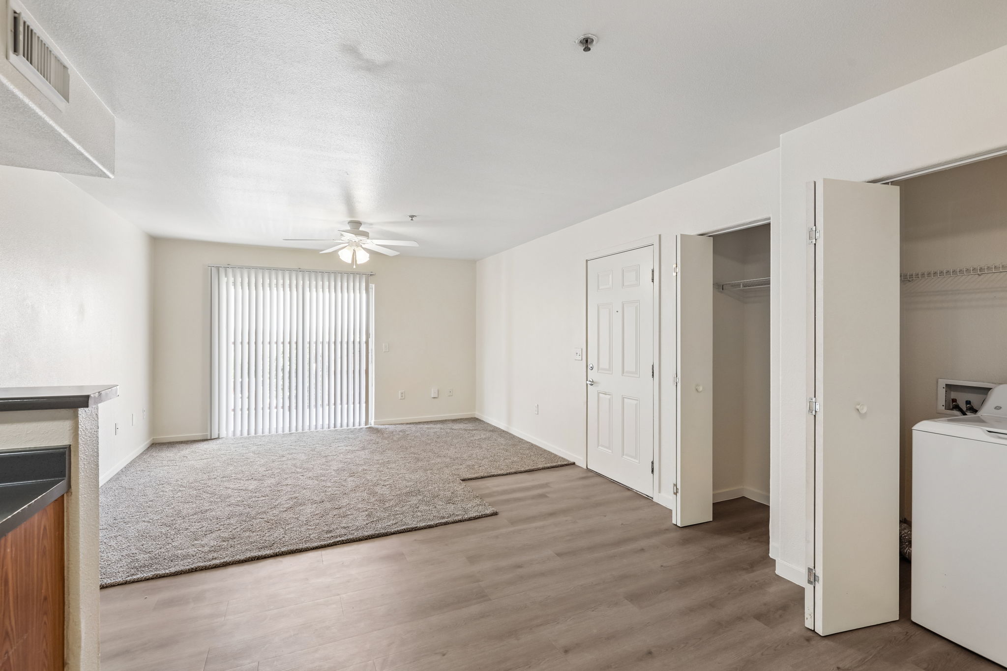 Dining area with view of kitchen and laundry closet
