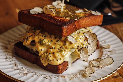 Honeysuckle's own ginger molasses cake sitting atop a decorative plate.