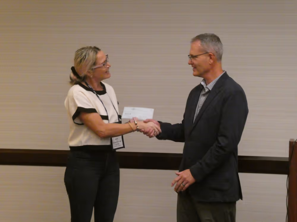 Man and woman shaking hands at the CERT 2024 River City Roundtable Conference
