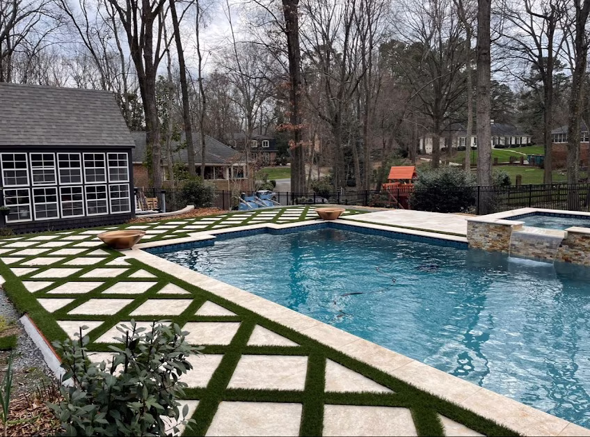 Pool design with turf and tile walkways.