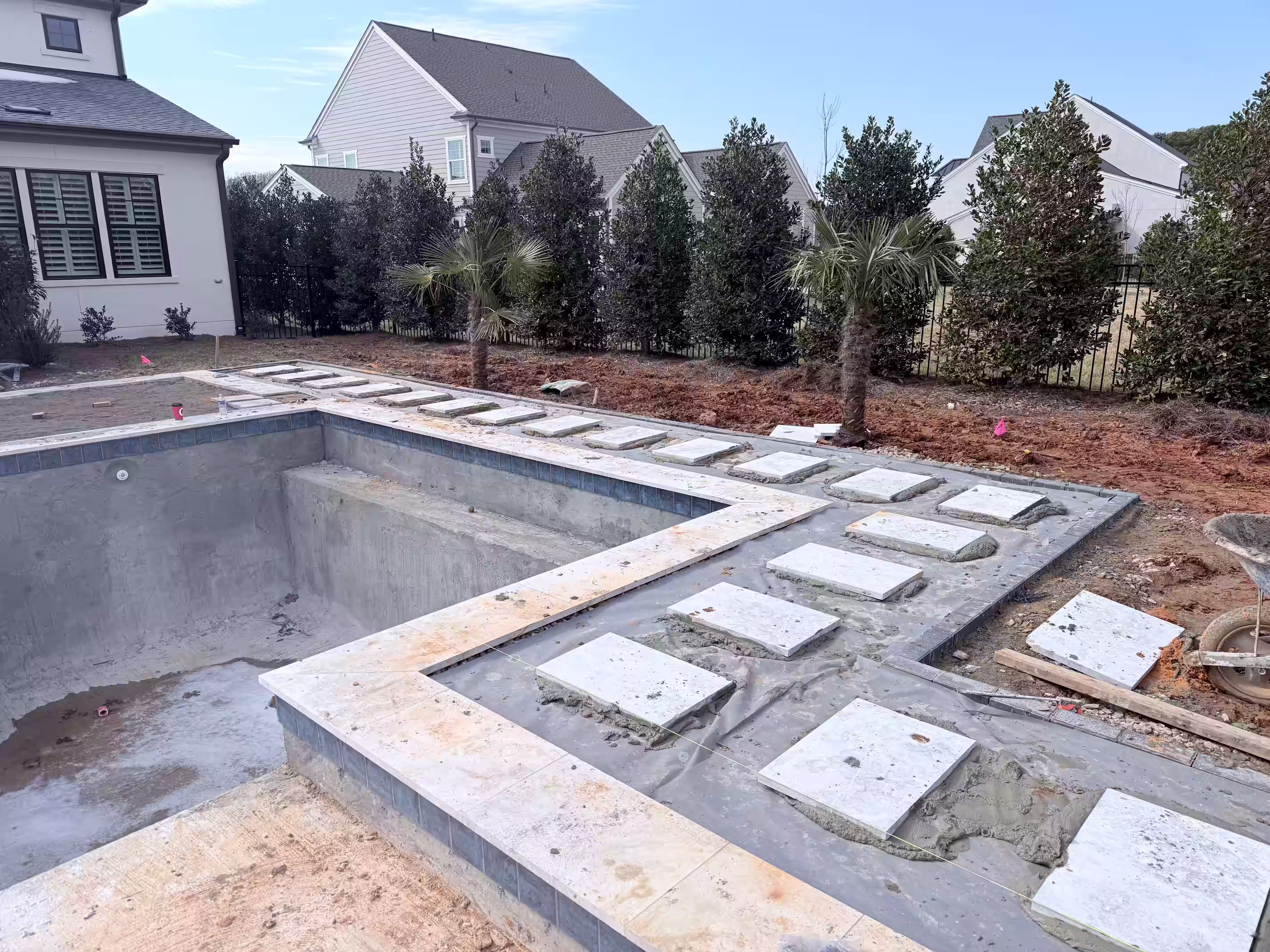 Custom pool design construction tiling and filling.