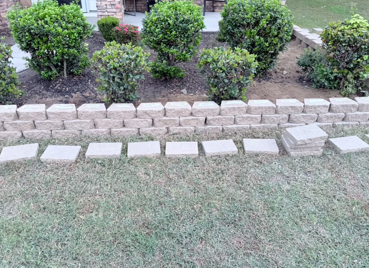 Raised brick design for small garden in front lawn.