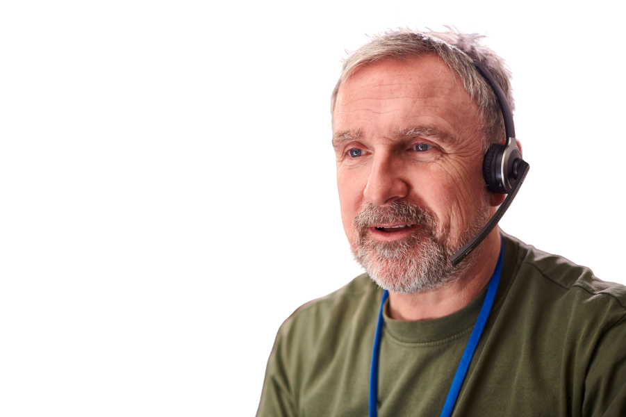 Older man on a headset, talking