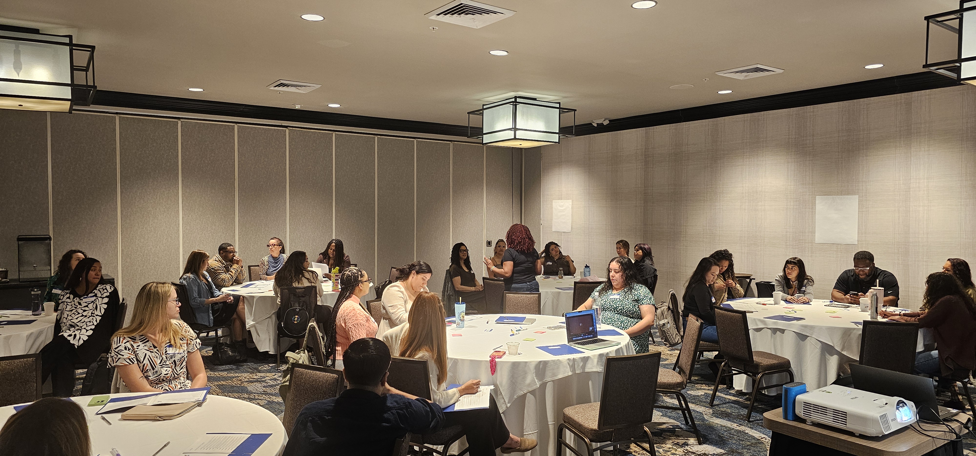 CCPU CliftonStrengths retreat — workshop attendees in collaborative discussion at round tables, March 2026